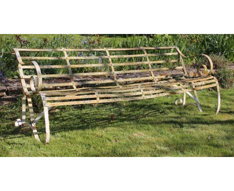 A 19TH CENTURY IRON STRAPWORK GARDEN BENCH with scrolling arms, 184cm wide