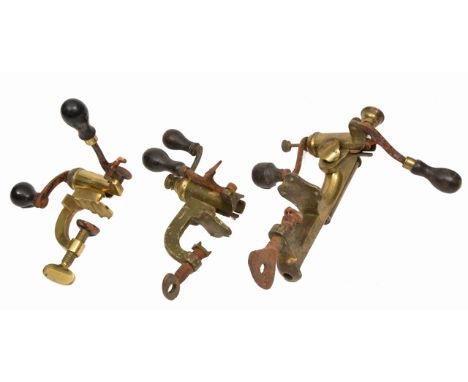 THREE ANTIQUE BRASS 12-GAUGE TURNOVER TOOLS, all with turned ebony handles, the largest 29cm in length (3)