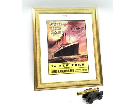 Brass model cannon on cast iron carriage dated 1796 L20cm; together with a framed reproduction poster for the maiden voyage o