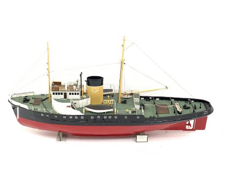 Large scale model of the motor Tug Turmoil, in OTS colours, on wooden stand, L135cm, W26cm, H66cm. Built 1945 the Turmoil was