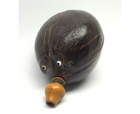 Napoleonic coconut bug bear flask with carved decoration and initials, inset glass eyes and turned boxwood pear shaped nozzle