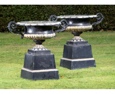 Garden Urn/Planter: A pair of cast iron urns on pedestals  2nd half 20th century  76cm high by 90cm wide 