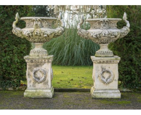 Planter: A pair of composition stone urns on pedestals  late 20th century 127cm high