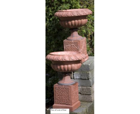Planter: A set of four late Victorian terracotta urns on pedestals  circa 1900 66cm high   