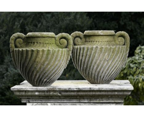Planter: † A pair of carved sandstone wrythen fluted two handled urns  modern 42cm high 