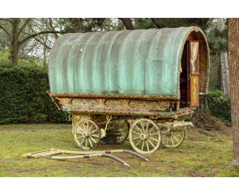 Shepherds Hut: A bowtop Gypsy caravan  20th century the painted wooden frame with canvas top, hinged hayrack and double stabl