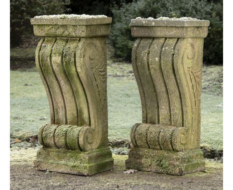 Architectural: † A pair of carved sandstone wall consoles carved with scrolls  modern 92cm high