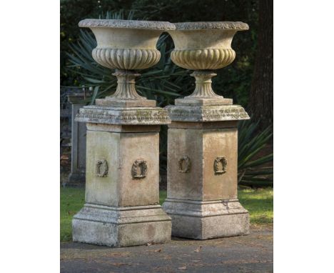 Planter: A pair of composition stone urns on pedestals   late 20th century  148cm high