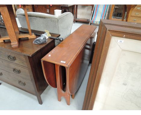 A vintage teak drop leaf table