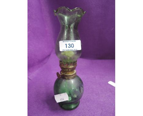 A green glasss oil lamp of small proportions