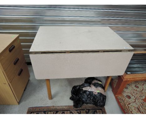 A vintage formica drop leaf kitchen table