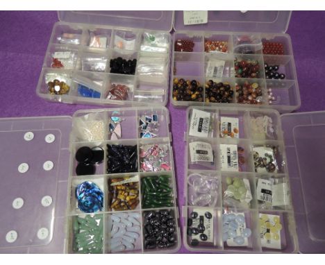 Four boxes of jewellery making beads and components including mineral, pearl, tigers eye, coral, etc
