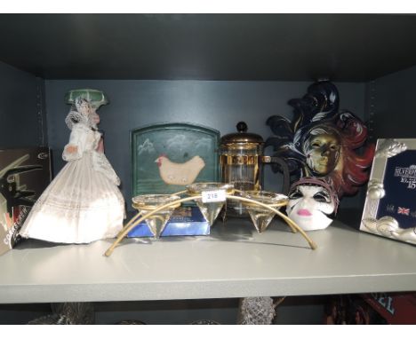 A selection of vintage trinkets and decorations including mask and photoframe