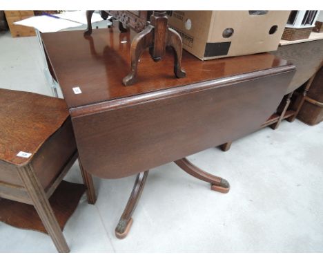 A vintage drop leaf pedestal table mahogany