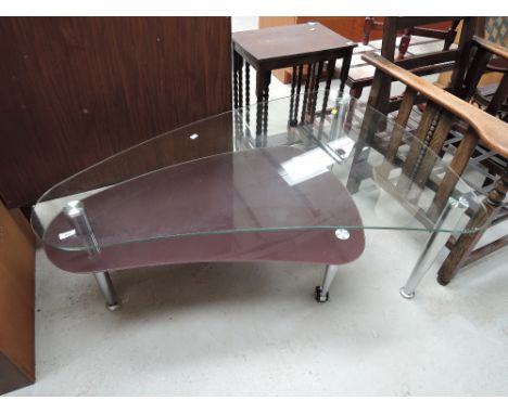 A vintage glass and chrome two tier coffee table