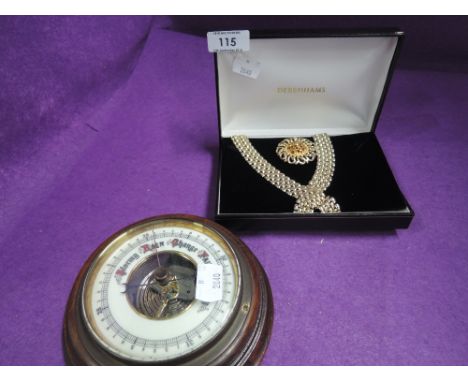A Debenhams necklace and broach and an enamel faced barometer