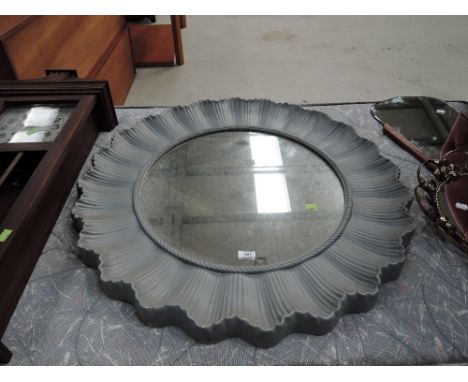 A vintage plastic wall mirror