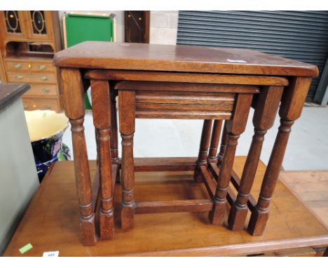 A vintage nest of oak tables
