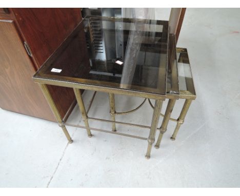 A vintage heavy brass and glass nest of tables havuing Corinthian style legs