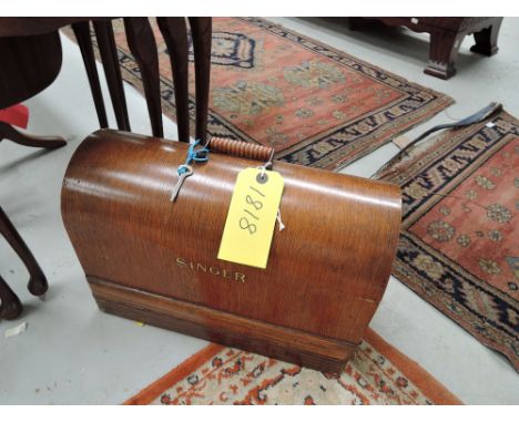 A vintage singer sewing machine in oak case