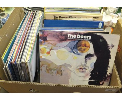 A box of LP records including The doors "Weird scenes inside the Gold Mine", a collection of memorabilia to include a program