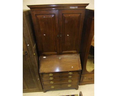 A mahogany bureau bookcase with four drawers on bracket feet