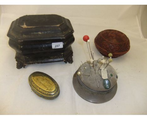An 18th Century Dutch brass tobacco box of oval form with figural decoration, a silver mounted hat pin stand with various pin