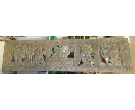 An Indian carved teak panel decorated with erotic scenes