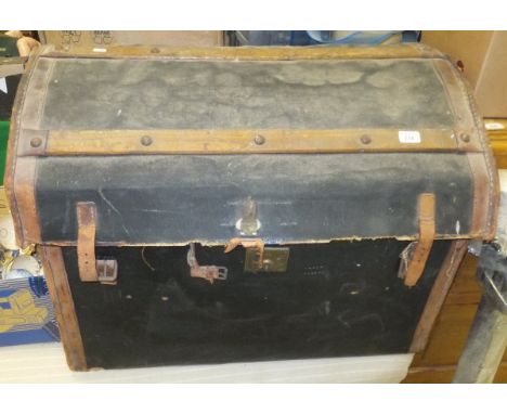 A canvas covered and leather bound dome top trunk containing two wine racks and a metal airer