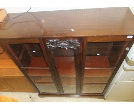 A mahogany two door display cabinet enclosing adjustable shelves, on bracket feet