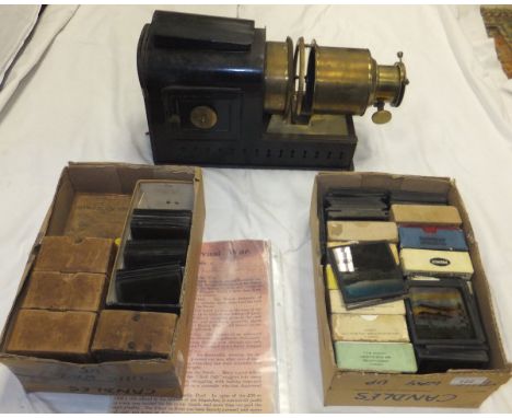 A brass and painted tin magic lantern, together with two boxes of various slides including Famous British Locomotives, Ramble