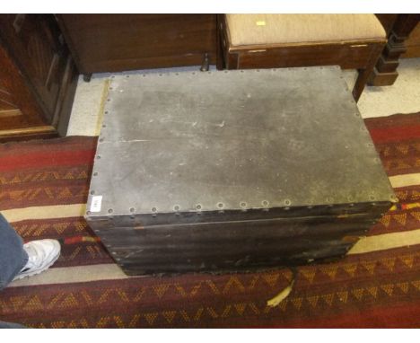 A black canvas covered pine trunk with studwork decoration, together with a circa 1900 oak tambour front cabinet with two sli