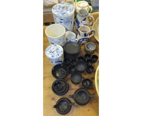 A collection of Wedgwood Black Basalt ware to include coffee cans and saucers, two small jugs, small bowls, small teapot (lid