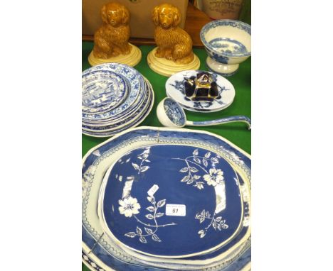 A pair of Staffordshire pottery treacle glazed spaniels on oval plinth bases, a 19th Century cream ware footed dish decorated