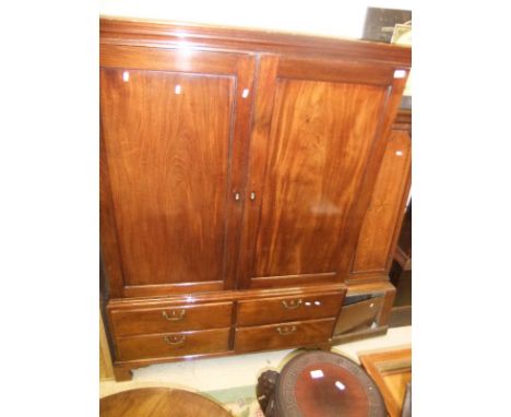 A 19th Century mahogany dwarf linen press with two cupboard doors over a bank of four drawers on bracket feet