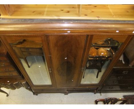 A mahogany wardrobe with two mirrored doors with two drawers on bracket feet