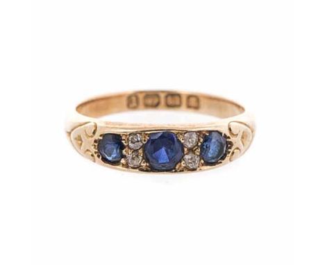 A SAPPHIRE RING set to the centre with three circular mixed-cut sapphires, embellished with four old-cut diamonds, impressed 