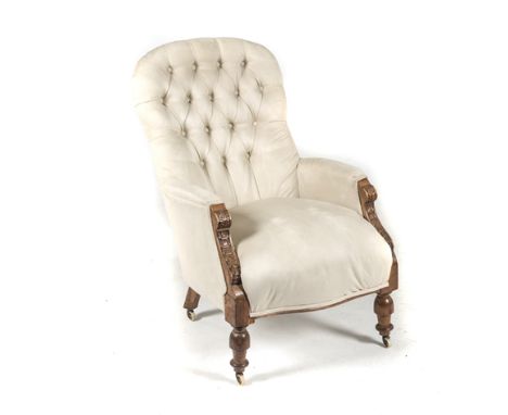 A VICTORIAN MAHOGANY AND UPHOLSTERED ARMCHAIR the padded button-back above a stuff-over seat, on upturned baluster legs, on c