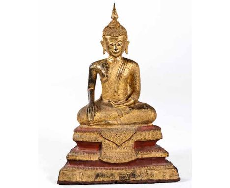 A GILT BRONZE FIGURE OF A SEATED BUDDHA, THAILAND, RATTANAKOSIN PERIOD, 19TH CENTURY raised on a tiered base, seated cross-le