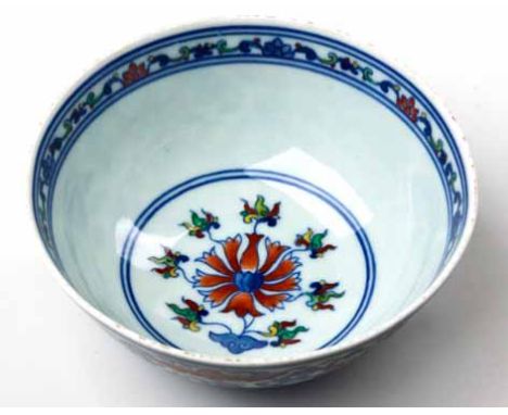 A CHINESE DOUCAI BOWL under-glaze with iron red over-glaze, yellow and green enamels, the exterior with scrolling lotuses, ba