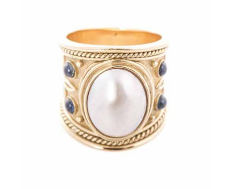 A MABÉ PEARL RING the broad tapered band with rope-work detail, centred with an oval mabé pearl, embellished on either side w