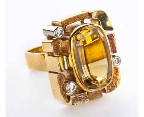 A GOLD DRESS RING centred with an oval mixed-cut citrine, the surround composed of textured free form shapes embellished with