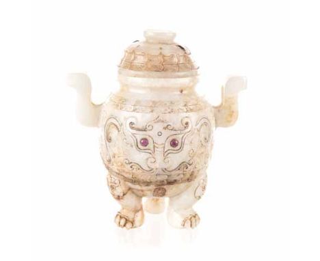 A CHINESE JADE TRIPOD CENSER AND COVER the ovoid body raised on three paw feet surmounted by masks, the sides carved with tao