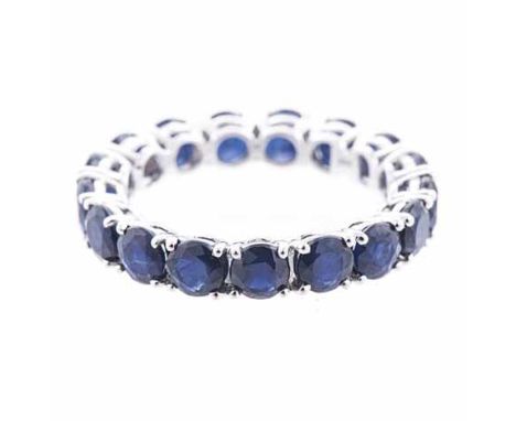 A SAPPHIRE ETERNITY RING claw-set throughout with circular mixed-cut sapphires weighing approximately 5.37cts in total, acid 