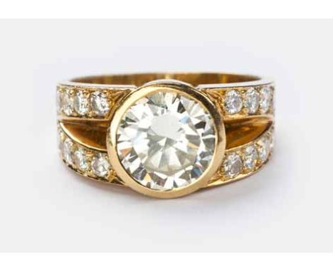 A DIAMOND RING centred with a bezel-set round brilliant-cut diamond weighing approximately 2.25cts, the bifurcated shoulders 
