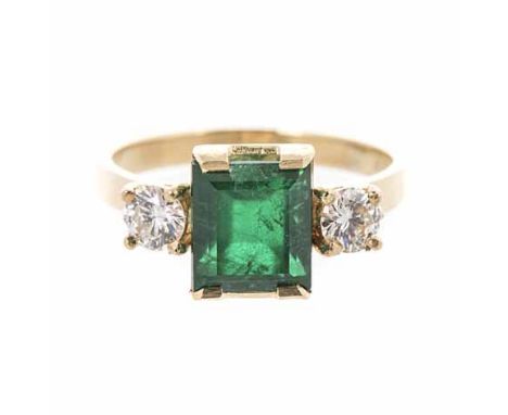 AN EMERALD AND DIAMOND RING centred with an emerald-cut emerald weighing approximately 1.96cts, flanked on either side by a r