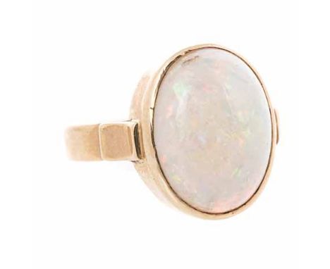 AN OPAL RING centred with a bezel-set oval cabochon opal,  impressed 18ct, size N 