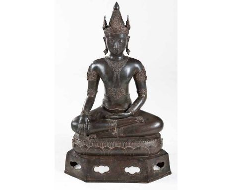 A BRONZE FIGURE OF A SEATED CROWNED AND BEJEWELED BUDDHA, SOUTHEAST ASIA seated in 'dhyanasana' posture on a lotus throne rai