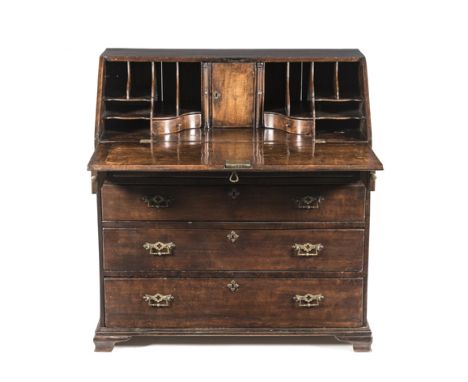 A GEORGE III FLAME MAHOGANY BUREAU the rectangular top above a hinged fall-front enclosing pigeon holes and drawers, in sizes