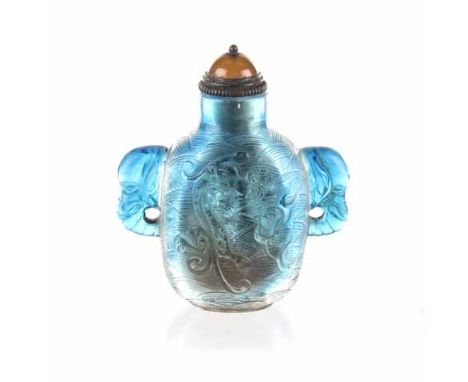 A CHINESE SKY BLUE PEKING GLASS SNUFF BOTTLE each side similarly carved with a 'Chilong' above waves facing a pearl amongst c